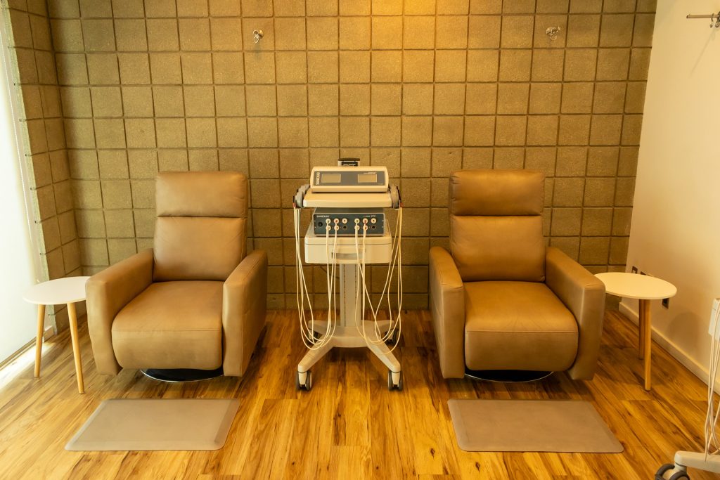 A professional treatment room featuring advanced yet non-invasive medical equipment, showcasing the cutting-edge therapies available at Holistic Primary Care in Palm Springs, CA.