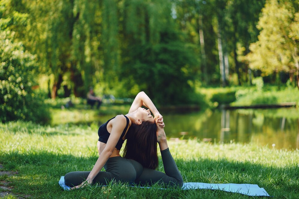 A woman confidently practicing yoga in a serene outdoor setting, symbolizing balanced wellness and vitality from women's health programs at Holistic Primary Care in Palm Springs, CA.